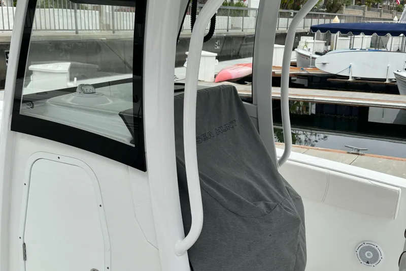 2021 Sea Hunt Gamefish 30 Coffin Box boat interior with covered seating and console.