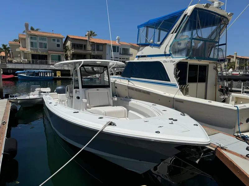 2021 Sea Hunt Gamefish 30 Coffin Box boat docked in a marina.