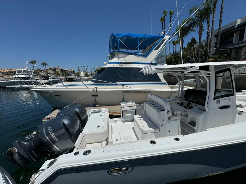 2021 Sea Hunt Gamefish 30 Coffin Box boat docked, featuring Yamaha engines, clear sky background.