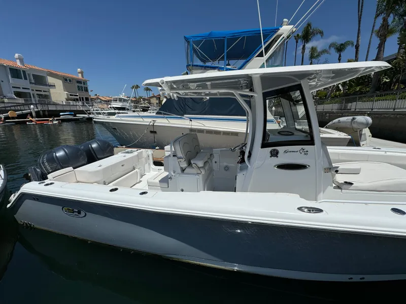 2021 Sea Hunt Gamefish 30 Coffin Box boat docked in marina, sunny day.