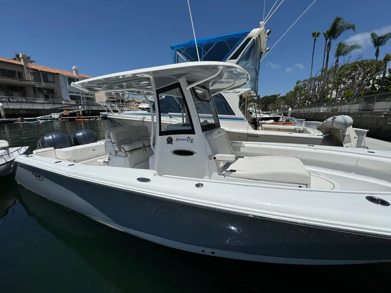 2021 Sea Hunt Gamefish 30 Coffin Box boat docked in marina under clear blue sky.