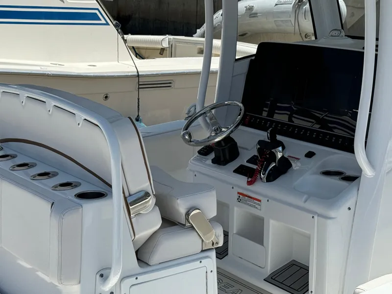 2021 Sea Hunt Gamefish 30 Coffin Box boat cockpit with steering wheel and controls.