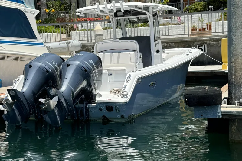 2021 Sea Hunt Gamefish 30 Coffin Box boat docked with dual engines.