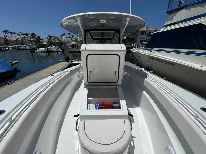 2021 Sea Hunt Gamefish 30 Coffin Box boat docked, open storage, sunny marina setting.