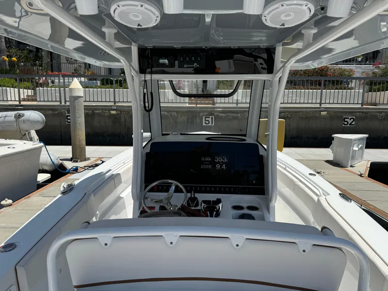 2021 Sea Hunt Gamefish 30 Coffin Box boat interior at dock, featuring helm and seating.
