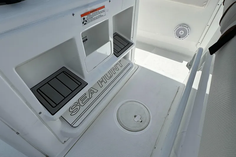 2021 Sea Hunt Gamefish 30 Coffin Box interior with storage compartments and Sea Hunt branding.
