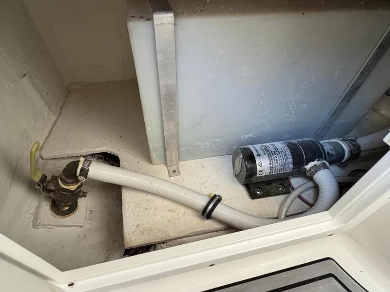 Bilge area of 2021 Sea Hunt Gamefish 30 Coffin Box with pump and hose.