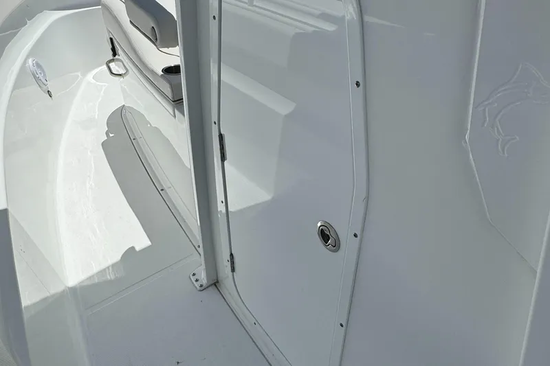 2021 Sea Hunt Gamefish 30 Coffin Box boat interior, featuring sleek white design and seating area.