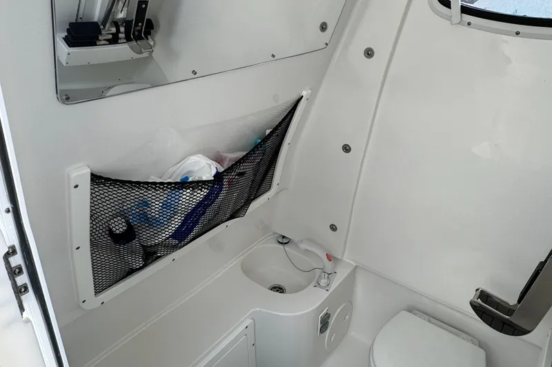2021 Sea Hunt Gamefish 30 Coffin Box interior with storage and toilet.