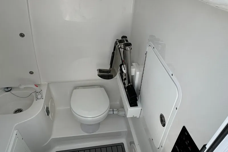 2021 Sea Hunt Gamefish 30 Coffin Box boat bathroom interior with toilet and sink.