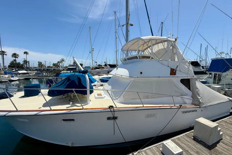 1971 Pacifica 44 Convertible yacht docked at a marina under a clear blue sky.