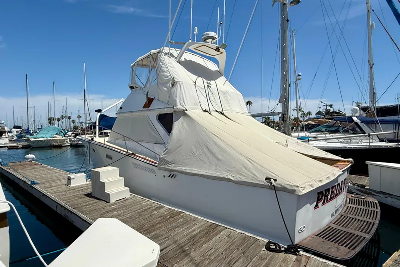 1971 Pacifica 44 Convertible yacht docked at marina, covered with protective tarp.