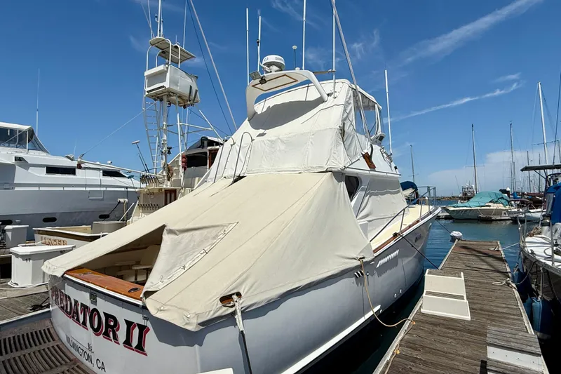 1971 Pacifica 44 Convertible yacht docked at marina under clear blue sky.