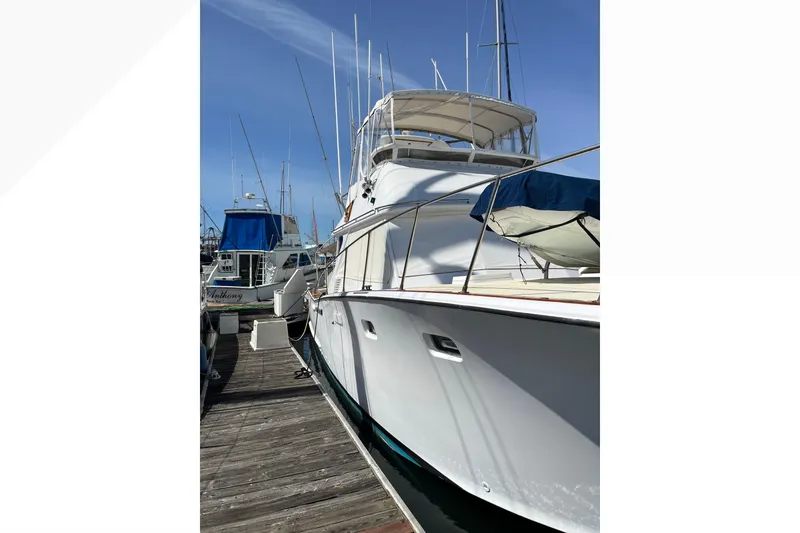1971 Pacifica 44 Convertible yacht docked at marina under clear blue sky.