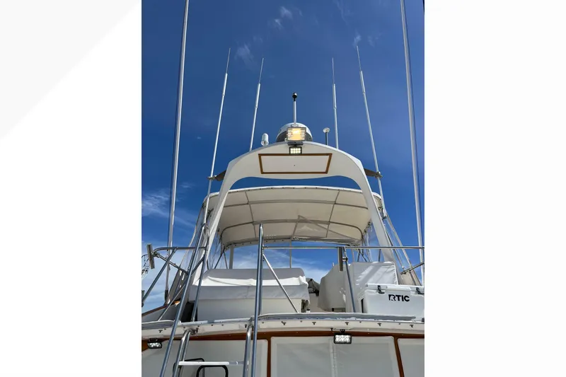 1971 Pacifica 44 Convertible yacht with antennas against a clear blue sky.