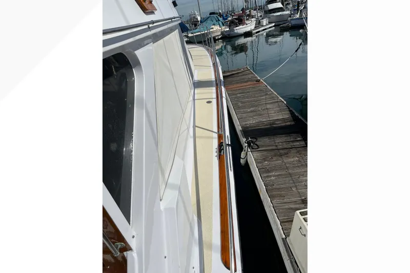 1971 Pacifica 44 Convertible yacht docked at a marina, showcasing sleek design and craftsmanship.