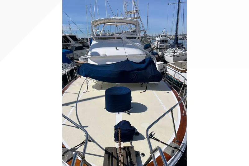 1971 Pacifica 44 Convertible yacht docked at marina, covered seating area, clear sky.