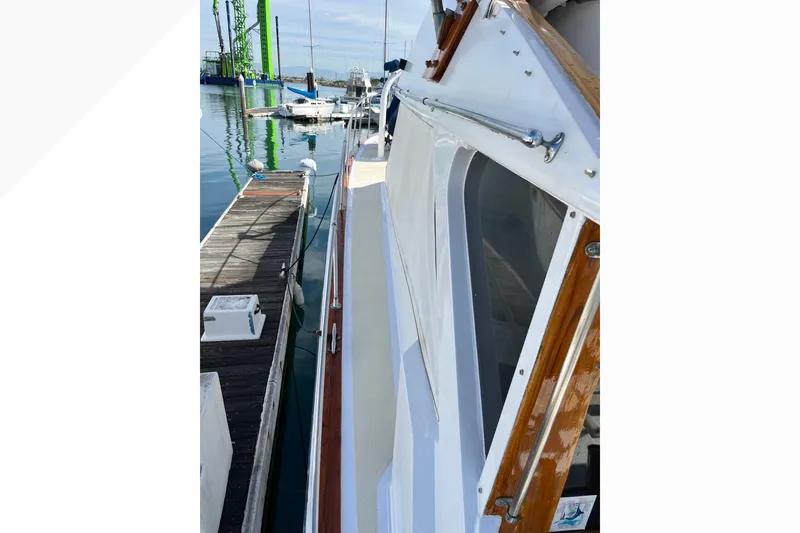 1971 Pacifica 44 Convertible yacht docked at marina, showcasing sleek design and wooden accents.