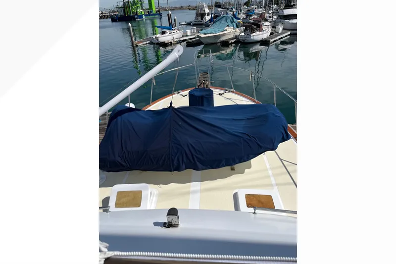 1971 Pacifica 44 Convertible yacht docked at marina, covered deck, surrounded by boats.