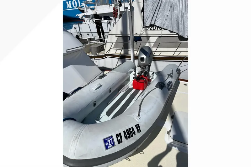 Inflatable boat with motor on deck of 1971 Pacifica 44 Convertible yacht.