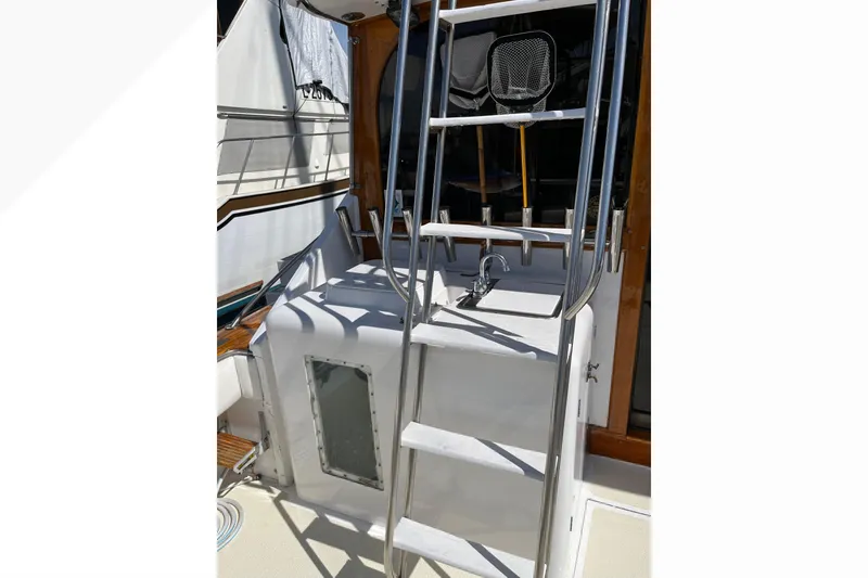 1971 Pacifica 44 Convertible yacht ladder and deck area with sink and storage.