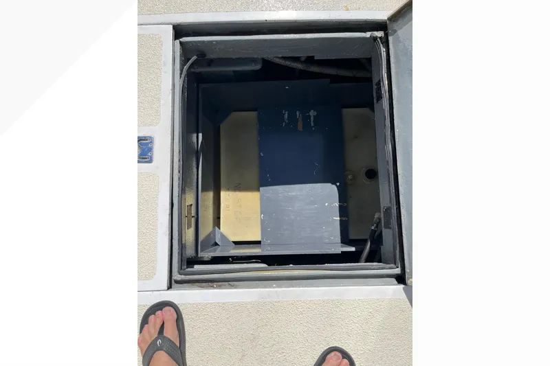 Open hatch on 1971 Pacifica 44 Convertible boat deck, revealing interior compartment.