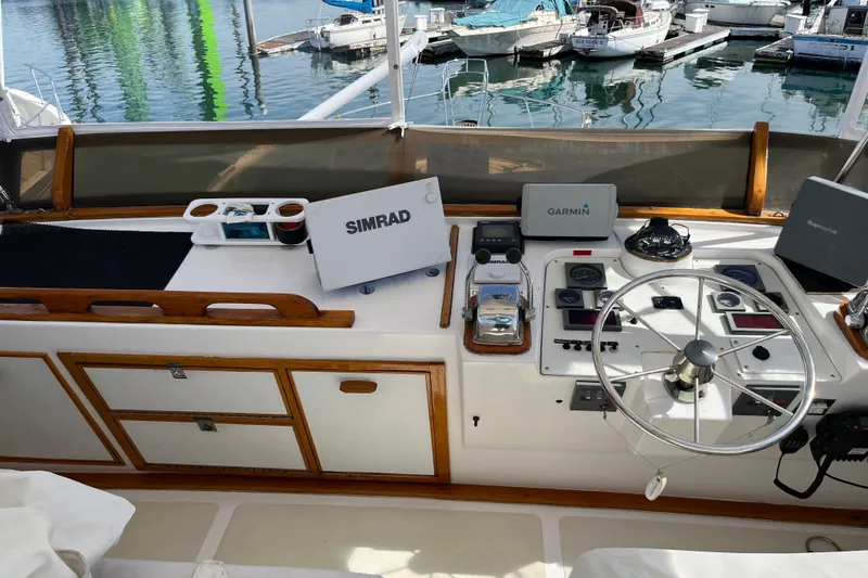 1971 Pacifica 44 Convertible yacht helm with navigation equipment and marina view.