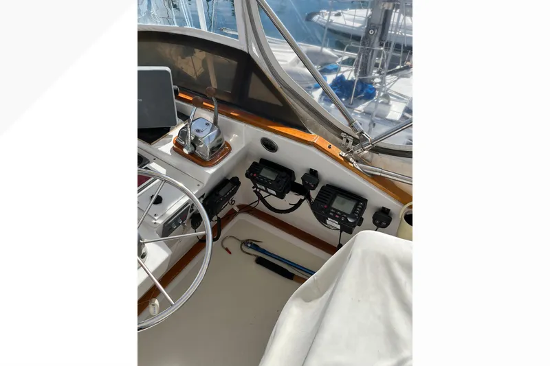 1971 Pacifica 44 Convertible yacht cockpit with steering wheel and navigation equipment.