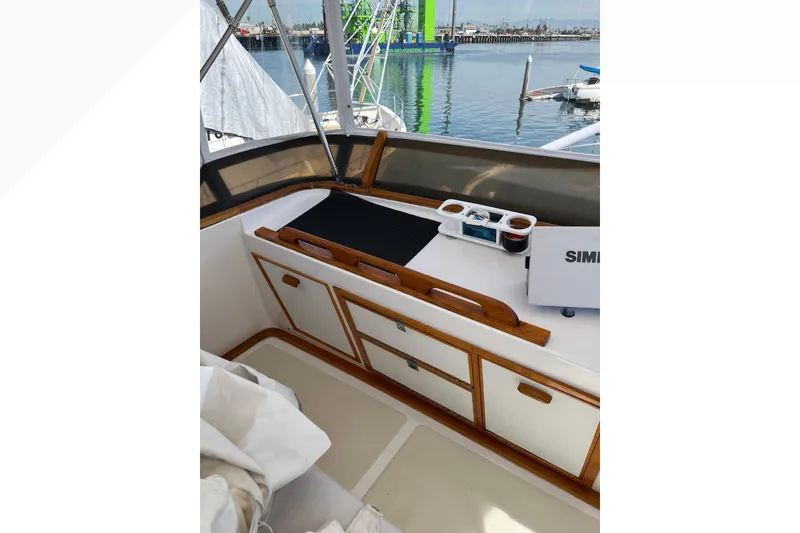 1971 Pacifica 44 Convertible boat interior with wooden cabinetry and marina view.