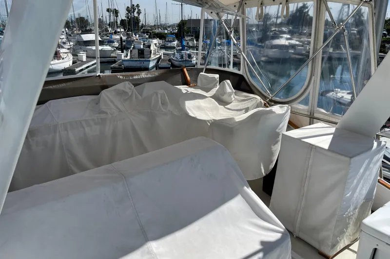 1971 Pacifica 44 Convertible yacht interior with covered seating, docked at a marina.