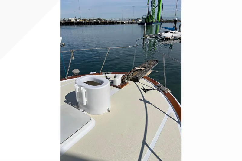 1971 Pacifica 44 Convertible yacht deck with railing, docked at marina.