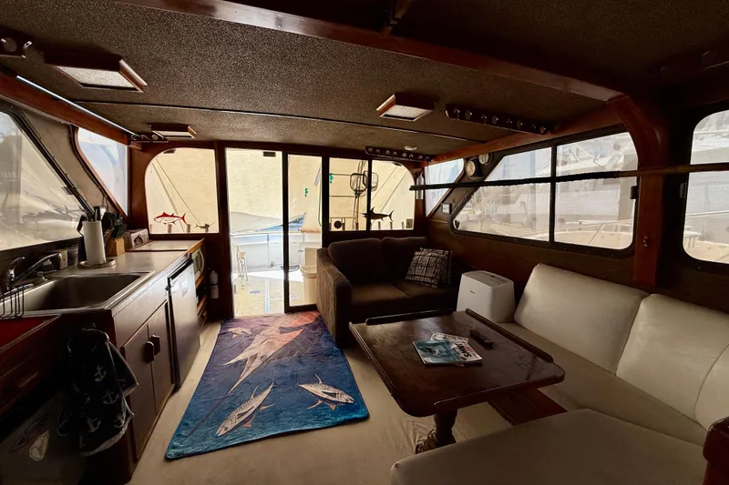 Interior of a 1971 Pacifica 44 Convertible boat with cozy seating and nautical decor.