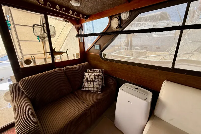 Interior of a 1971 Pacifica 44 Convertible yacht with cozy seating and decor.