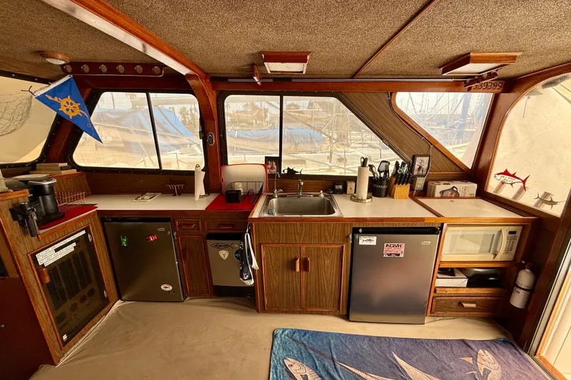 Interior of a 1971 Pacifica 44 Convertible boat with a well-equipped kitchen area.