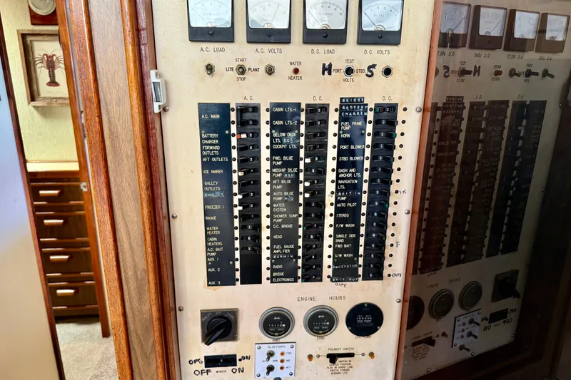 Electrical control panel on a 1971 Pacifica 44 Convertible boat, featuring various switches and gauges.