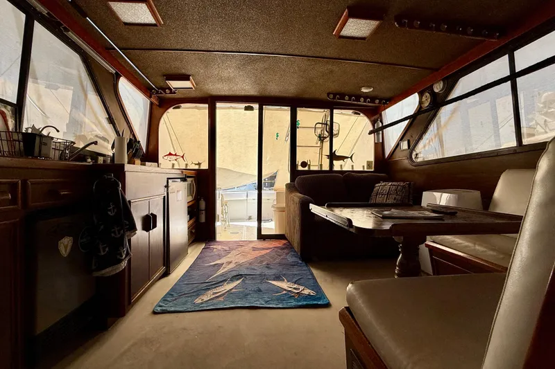 Interior of a 1971 Pacifica 44 Convertible boat with cozy seating and nautical decor.
