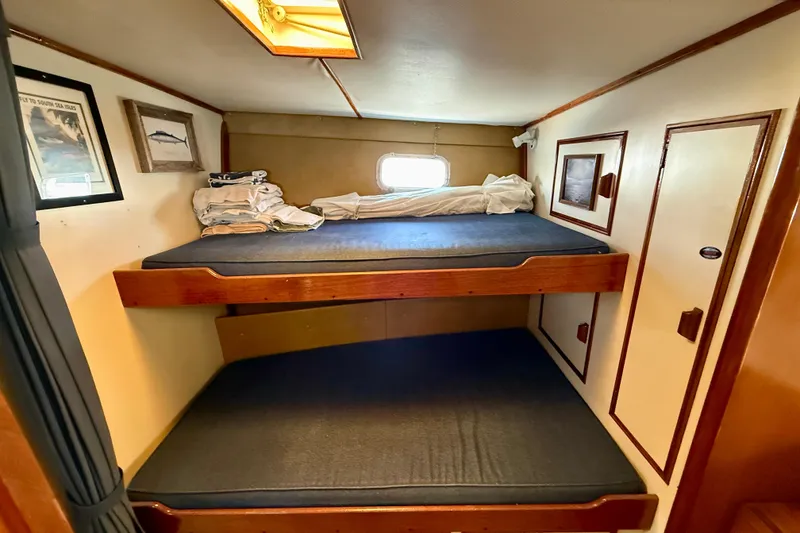 1971 Pacifica 44 Convertible cabin with bunk beds, nautical decor, and cozy interior.