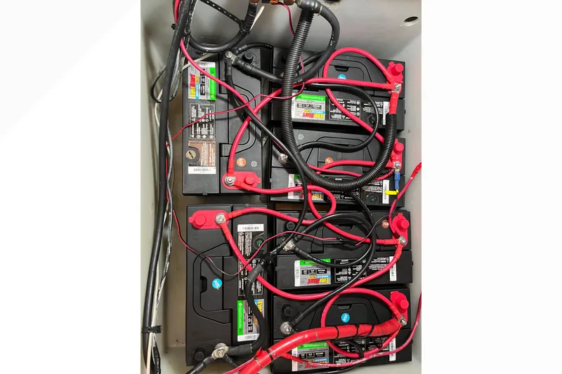 Battery setup with red and black cables in a 1971 Pacifica 44 Convertible.