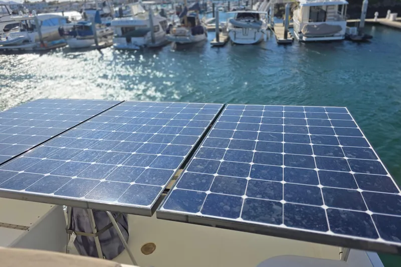 Solar panels on a 2000 McKinna 48 Pilothouse yacht in a marina setting.