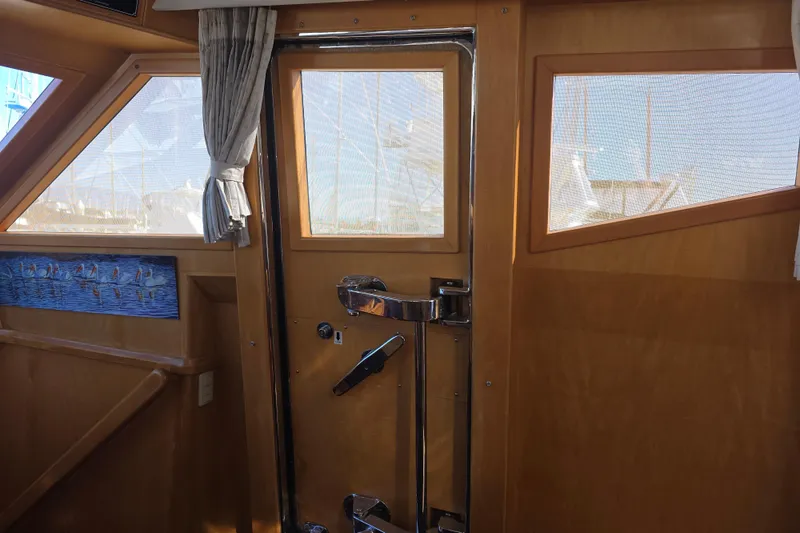 Interior of 2000 McKinna 48 Pilothouse with wooden door and windows.