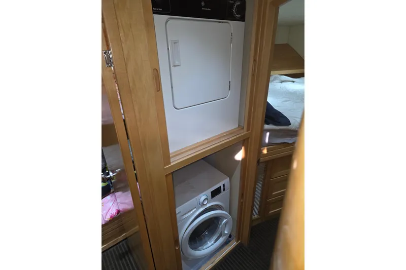 Laundry area inside 2000 McKinna 48 Pilothouse yacht, featuring washer and dryer.