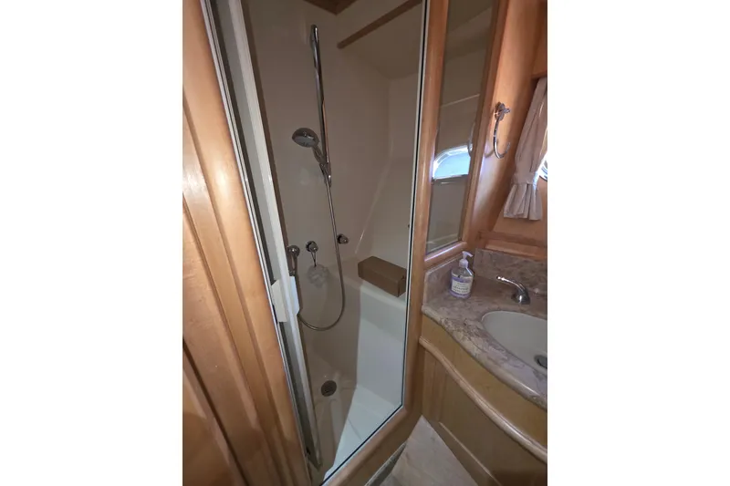 Bathroom interior of 2000 McKinna 48 Pilothouse yacht with shower and sink.