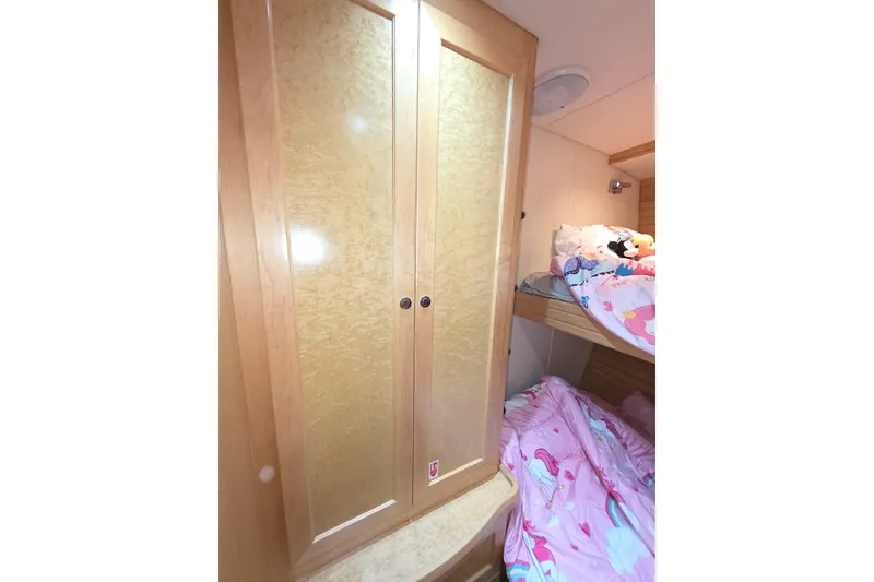 Interior of 2000 McKinna 48 Pilothouse with wooden cabinet and cozy bunk beds.