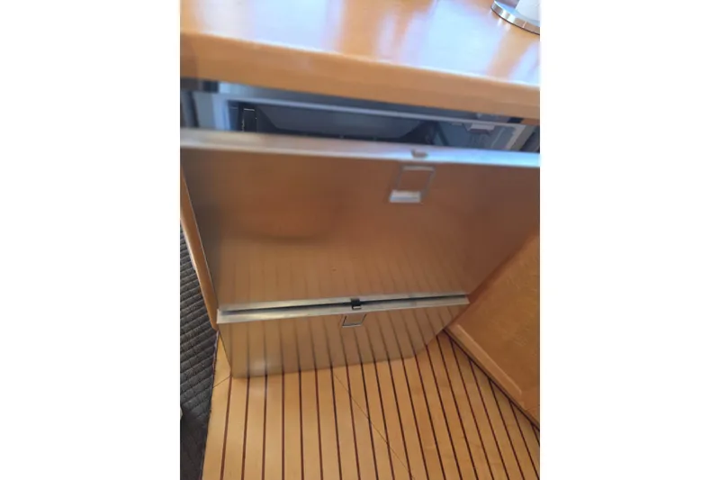 Open drawer in McKinna 48 Pilothouse yacht, showcasing wooden interior, 2000 model.