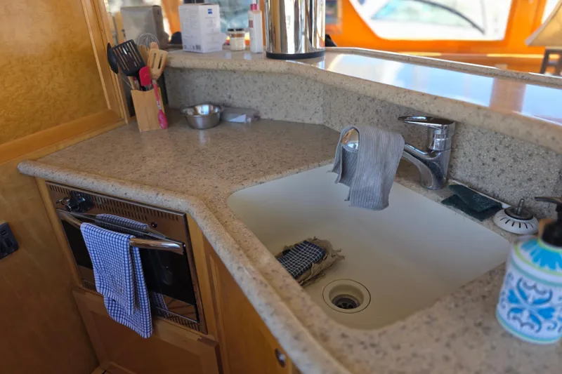 Kitchen area of a 2000 McKinna 48 Pilothouse yacht with sink and countertop.