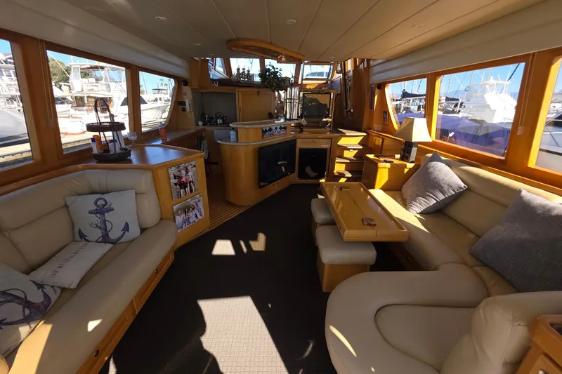 Luxurious interior of 2000 McKinna 48 Pilothouse yacht with elegant seating and decor.