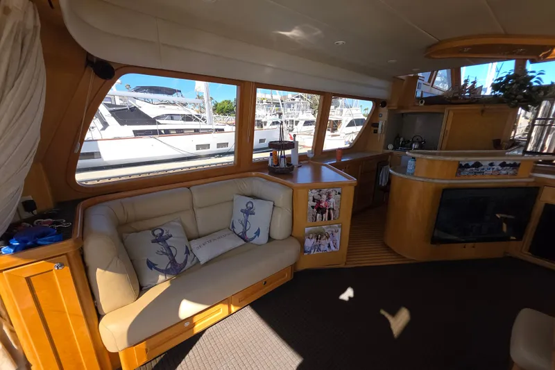 Luxurious interior of 2000 McKinna 48 Pilothouse yacht with cozy seating and nautical decor.