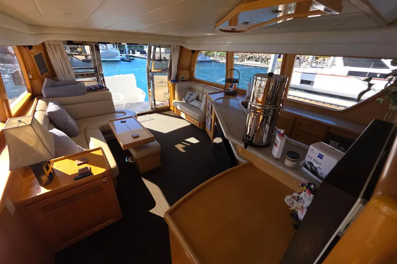 Luxurious interior of 2000 McKinna 48 Pilothouse yacht with elegant seating and scenic views.
