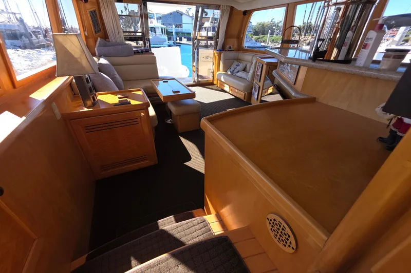Luxurious interior of a 2000 McKinna 48 Pilothouse yacht with elegant wood finishes.