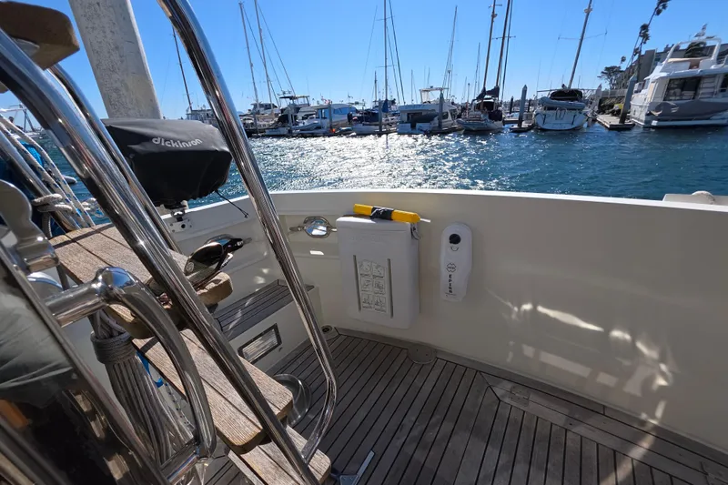 2000 McKinna 48 Pilothouse yacht deck with marina view and clear blue sky.